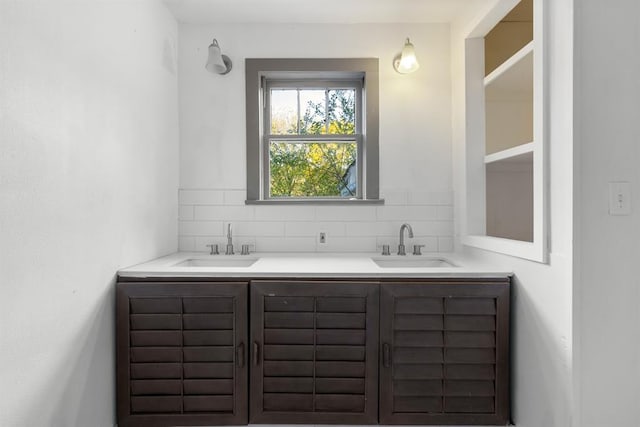 bathroom featuring vanity and backsplash