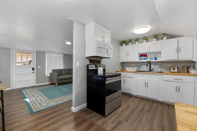 kitchen featuring white microwave, stainless steel electric stove, dark wood-style floors, white cabinetry, and a sink