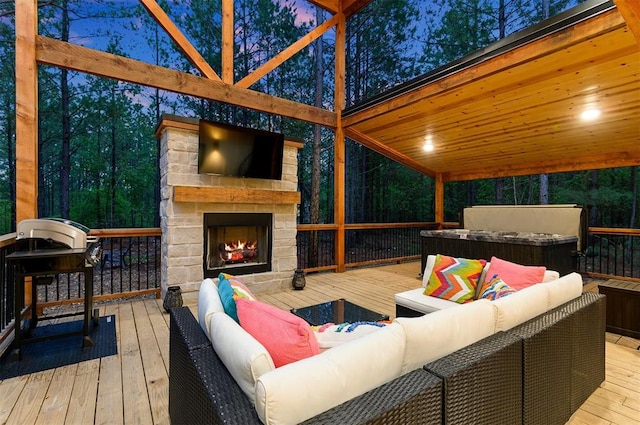 wooden deck featuring an outdoor living space with a fireplace