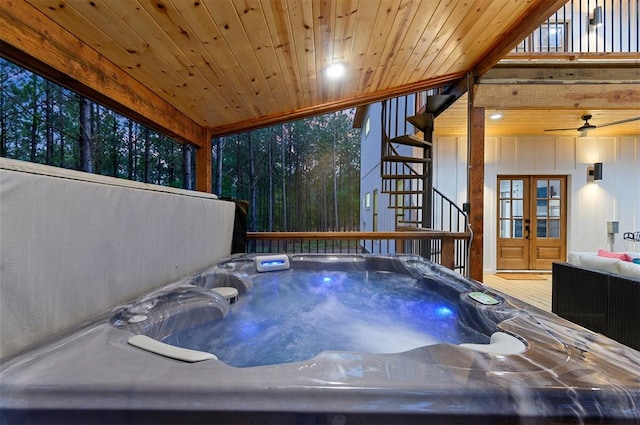 view of swimming pool with a hot tub and a wooden deck