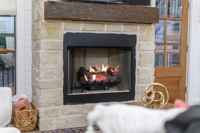 interior details featuring a stone fireplace