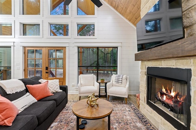 sunroom with french doors, vaulted ceiling, ceiling fan, and wooden ceiling