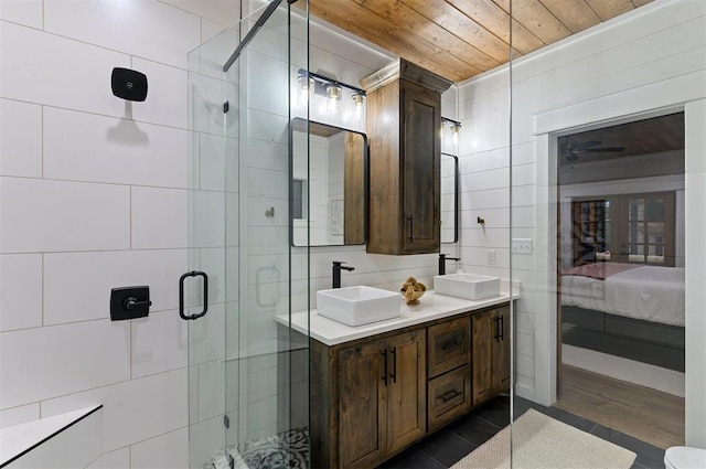 bathroom featuring wooden ceiling, hardwood / wood-style floors, vanity, a shower with shower door, and tile walls