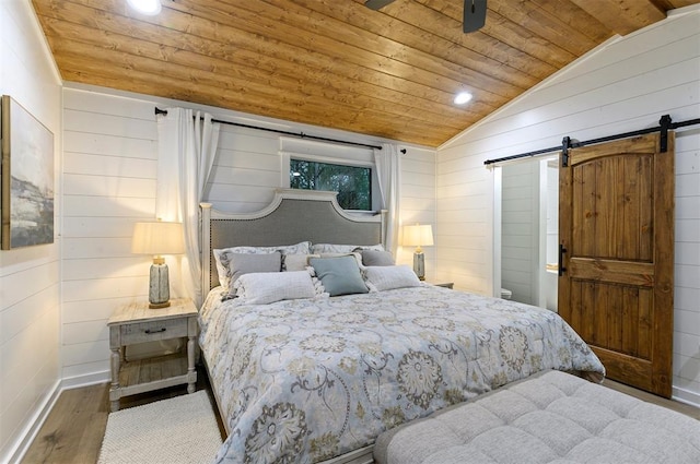 bedroom featuring a barn door, wood ceiling, lofted ceiling, and wood-type flooring