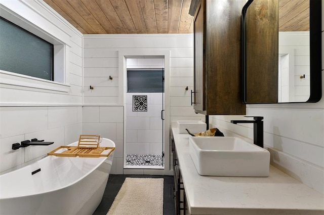 bathroom with wooden walls, a washtub, vanity, and wood ceiling