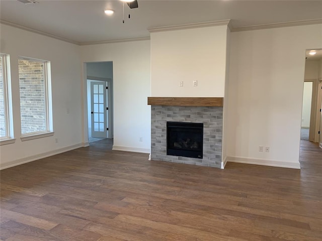 unfurnished living room featuring dark hardwood / wood-style flooring, ceiling fan, and crown molding