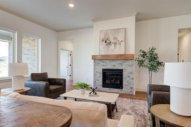 living area with ornamental molding, a fireplace, wood finished floors, and recessed lighting