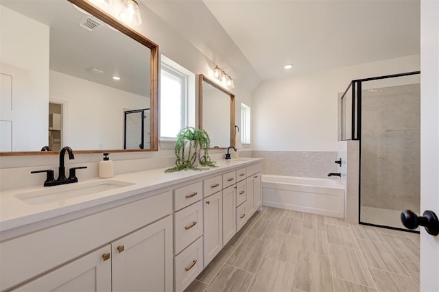 full bathroom featuring double vanity, visible vents, a stall shower, a sink, and a bath