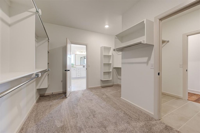 spacious closet with light colored carpet