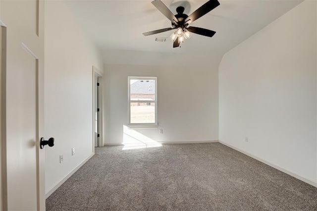 carpeted spare room featuring visible vents, ceiling fan, and baseboards