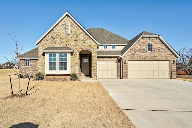 view of front of home with driveway, a shingled roof, stone siding, and brick siding