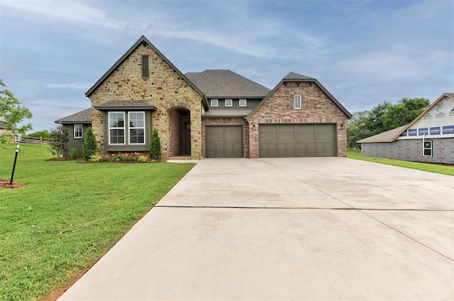 14500 Rushing Ln, Edmond, OK 73025 - view of front of home featuring concrete driveway, a front yard, brick siding, and roof with shingles
