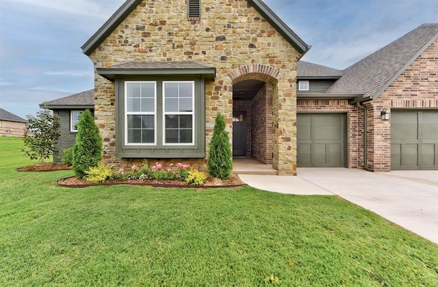 14500 Rushing Ln, Edmond, OK 73025 - view of front of home featuring a shingled roof, driveway, a garage, a front yard, and stone siding