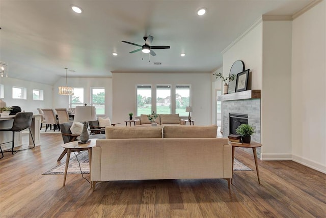 14500 Rushing Ln, Edmond, OK 73025 - living area featuring a ceiling fan, a glass covered fireplace, wood finished floors, ornamental molding, and baseboards