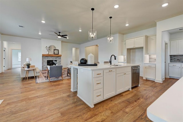 14500 Rushing Ln, Edmond, OK 73025 - kitchen featuring stainless steel dishwasher, a ceiling fan, recessed lighting, light countertops, and a sink