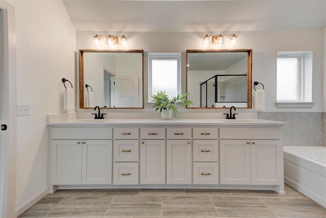 14500 Rushing Ln, Edmond, OK 73025 - full bathroom featuring a stall shower, double vanity, and a bath