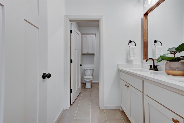 14500 Rushing Ln, Edmond, OK 73025 - full bath featuring tile patterned flooring, toilet, double vanity, and baseboards