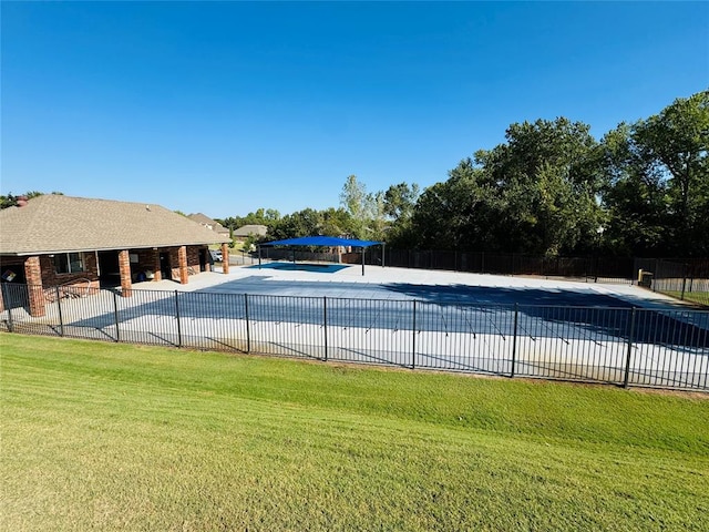 view of swimming pool featuring a yard and a patio area