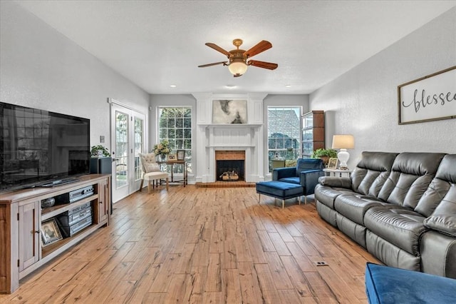 living room with ceiling fan and light hardwood / wood-style floors