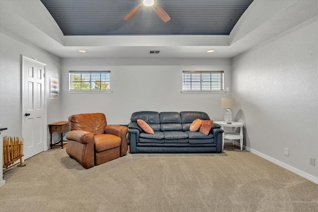 carpeted living room with plenty of natural light, a raised ceiling, and wooden ceiling