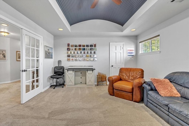 sitting room with lofted ceiling, carpet, ceiling fan, a tray ceiling, and french doors