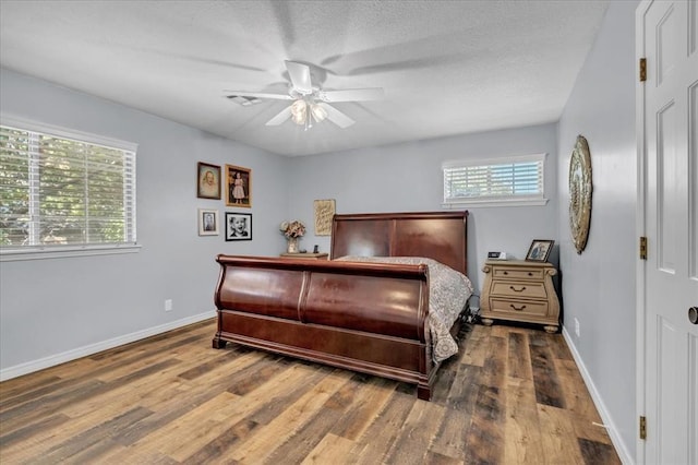 bedroom with ceiling fan and dark hardwood / wood-style flooring