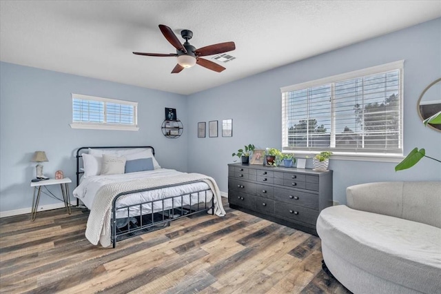 bedroom featuring hardwood / wood-style flooring and ceiling fan