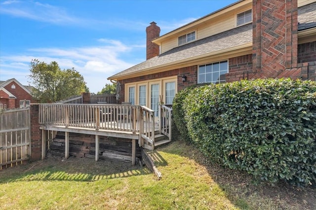 back of house featuring a yard and a deck