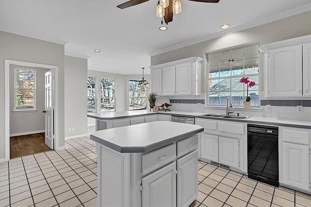 kitchen featuring white cabinetry, sink, light tile patterned flooring, and a kitchen island