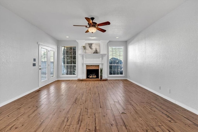 unfurnished living room featuring light hardwood / wood-style floors and ceiling fan