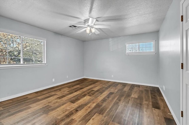 unfurnished room featuring a textured ceiling, dark hardwood / wood-style floors, and ceiling fan