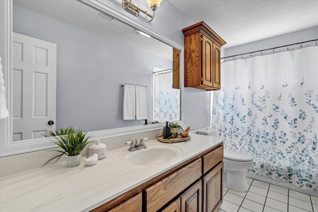 bathroom with tile patterned floors, toilet, and vanity