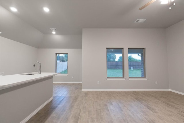 12333 SW 30th St, Yukon, OK 73099 - empty room featuring a sink, light wood-style flooring, plenty of natural light, a ceiling fan, and recessed lighting