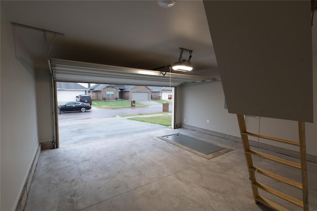 12333 SW 30th St, Yukon, OK 73099 - garage with baseboards and a garage door opener