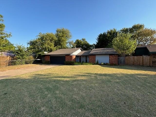 view of front of home with a garage and a front lawn