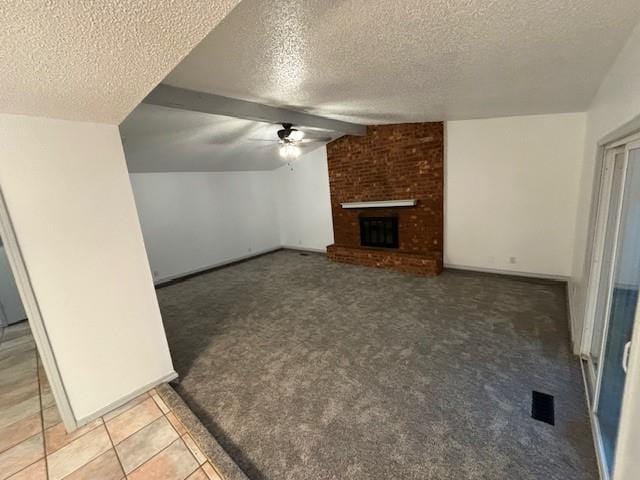 unfurnished living room with ceiling fan, lofted ceiling, a textured ceiling, and a brick fireplace