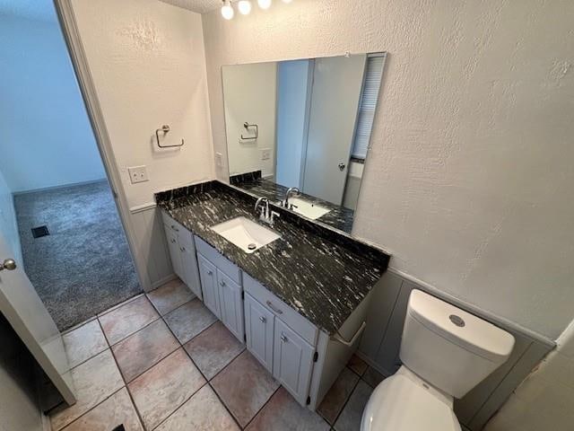 bathroom with tile patterned floors, vanity, and toilet