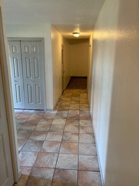 corridor featuring light tile patterned floors