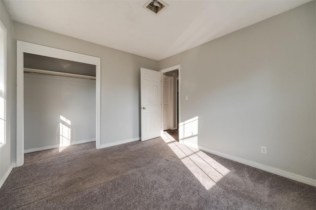 unfurnished bedroom with carpet floors and a closet