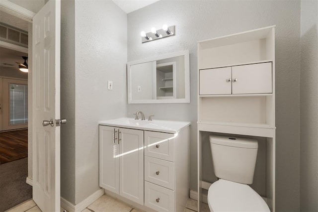 bathroom with tile patterned flooring, vanity, and ceiling fan