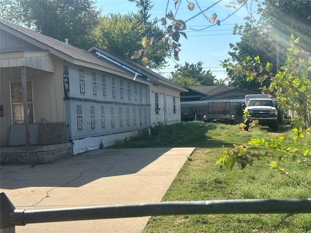 view of property exterior with a lawn