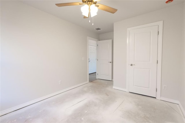 unfurnished bedroom with a ceiling fan, visible vents, concrete floors, and baseboards