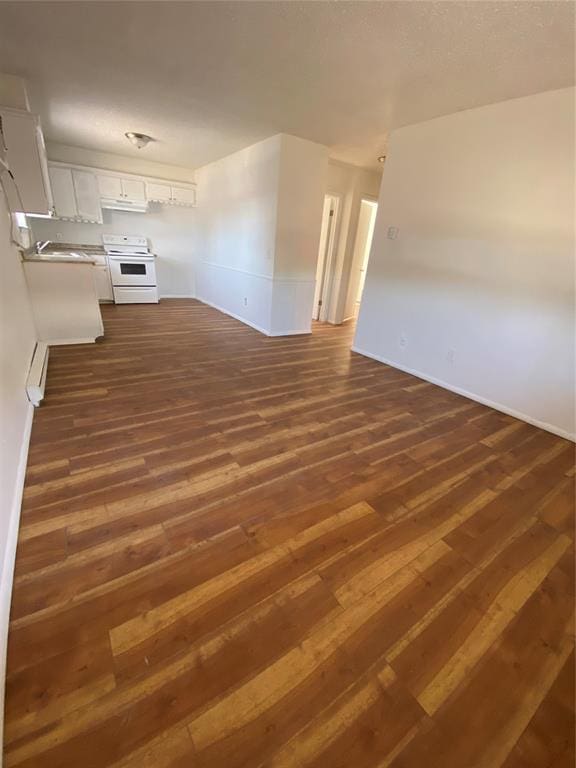 unfurnished living room featuring dark hardwood / wood-style floors and sink