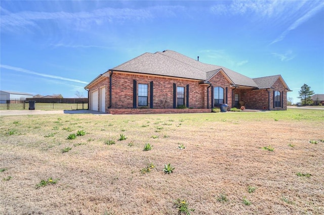 view of front of property featuring a garage and a front lawn