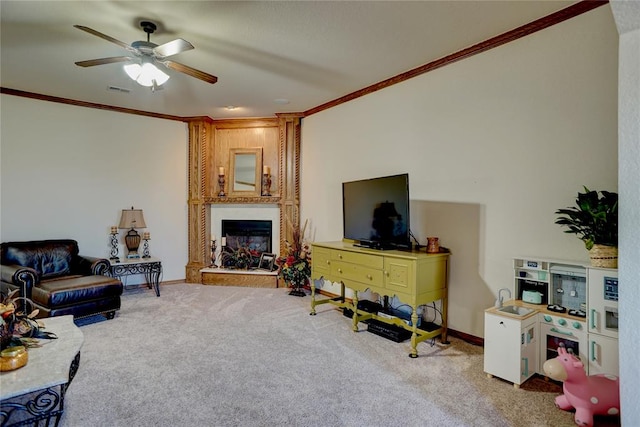 carpeted living room featuring a fireplace, ceiling fan, and ornamental molding