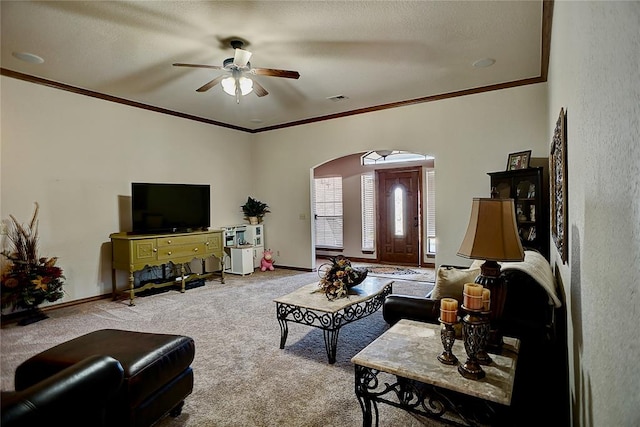 carpeted living room featuring ceiling fan and ornamental molding