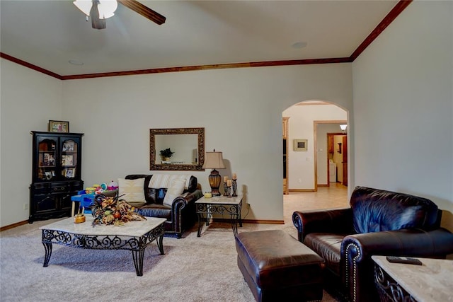 carpeted living room with ceiling fan and crown molding