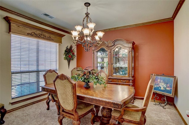 carpeted dining area featuring a chandelier and ornamental molding