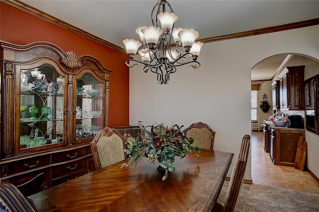 dining space featuring an inviting chandelier, light tile patterned flooring, and ornamental molding