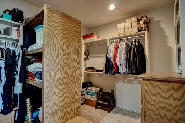 walk in closet featuring light colored carpet